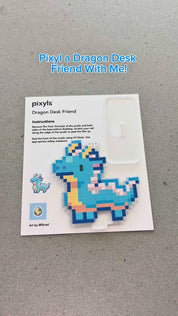I think everyone needs a little dragon desk friend! It’s too cute 😆🩵 #pixyls #satisfyingvideo #stickerbynumber #stickerart #pixelart #pixelstickers #sticker #stickerart #crafting #craft #craftkit #dragon 